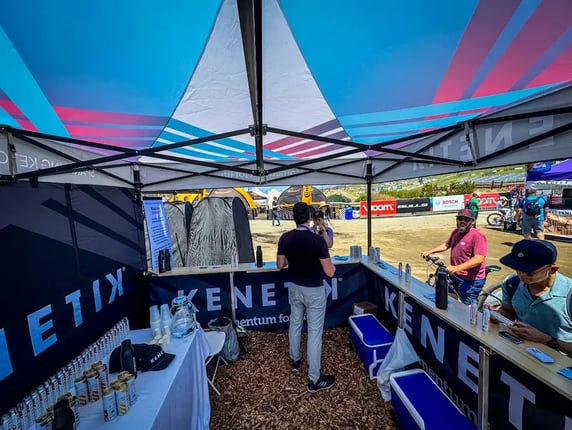 Inside Kenetik's 10x10 custom pop-up tent at Sea Otter Classic