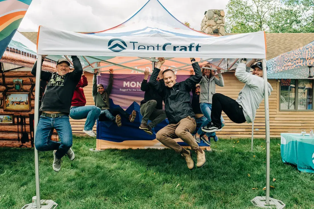 TentCraft employees hang on to a heavy-duty MONARCHTENT