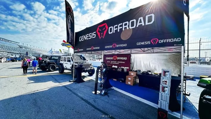 A billboard-style MONARCHSTOREFRONT pop-up canopy tent for an outdoor trade show.