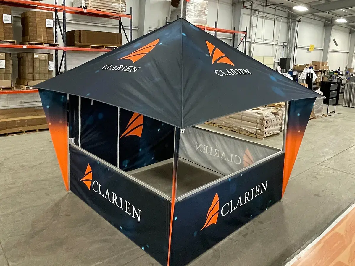 A custom-printed 10x10 MONARCHREACH with custom triangle leg banners, double-sided printed back tent wall, and three custom printed half walls.