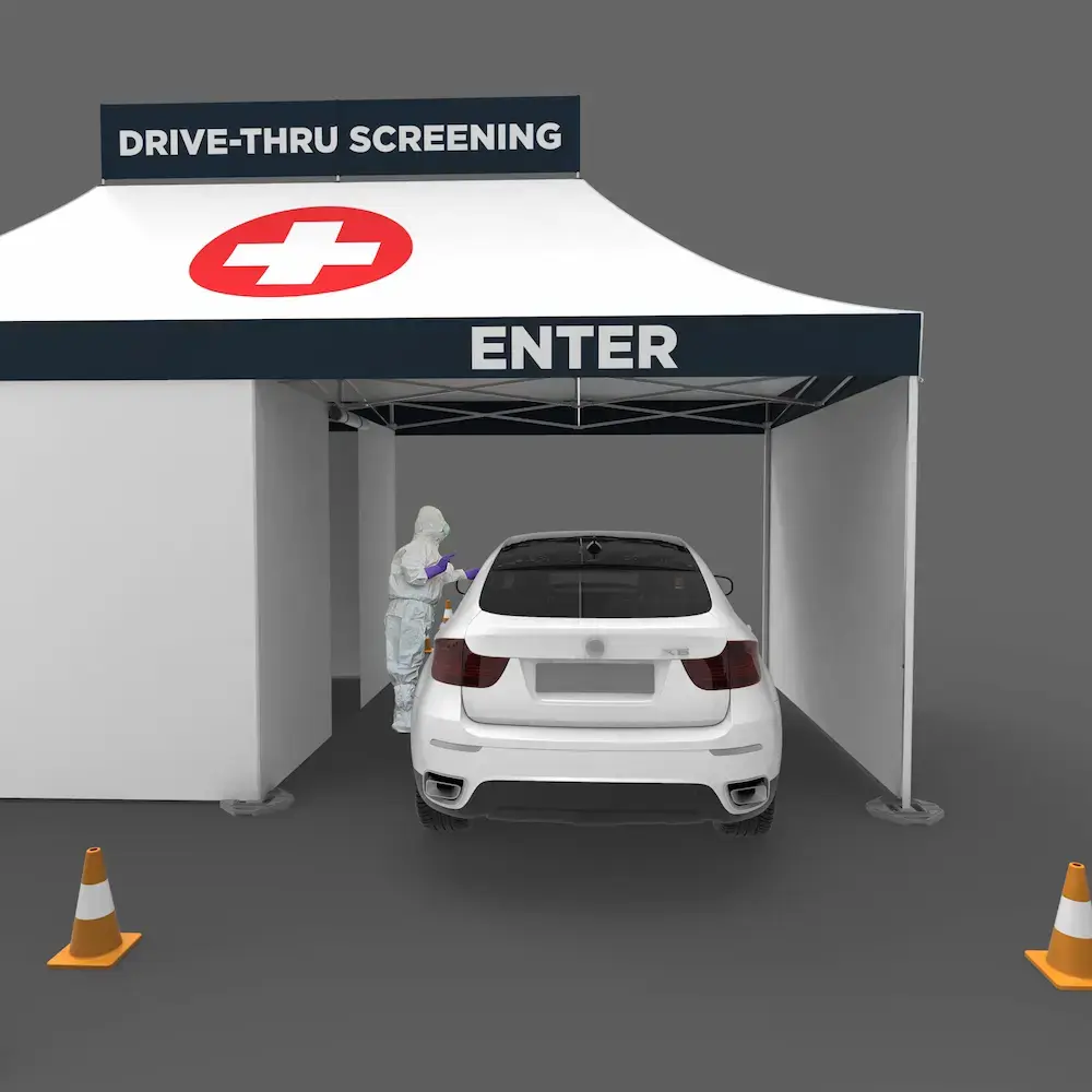 entrance of a white drive thru coronavirus testing tent with a car in it and medical professional interacting with a patient