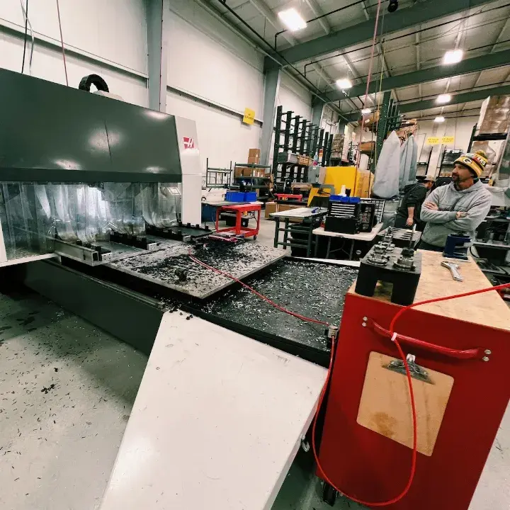 TentCraft employee works a machine to fabricate metal for pop-up tent frames.