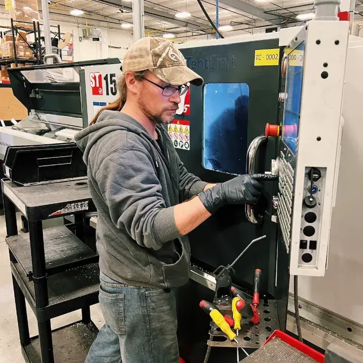 TentCraft employee fabricates metal for pop-up tent frames